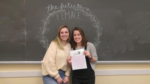 Meredith Riley (left) and Sarah Riback hold a letter to a U.S. representative. (Rosie Kean/The Diamondback)